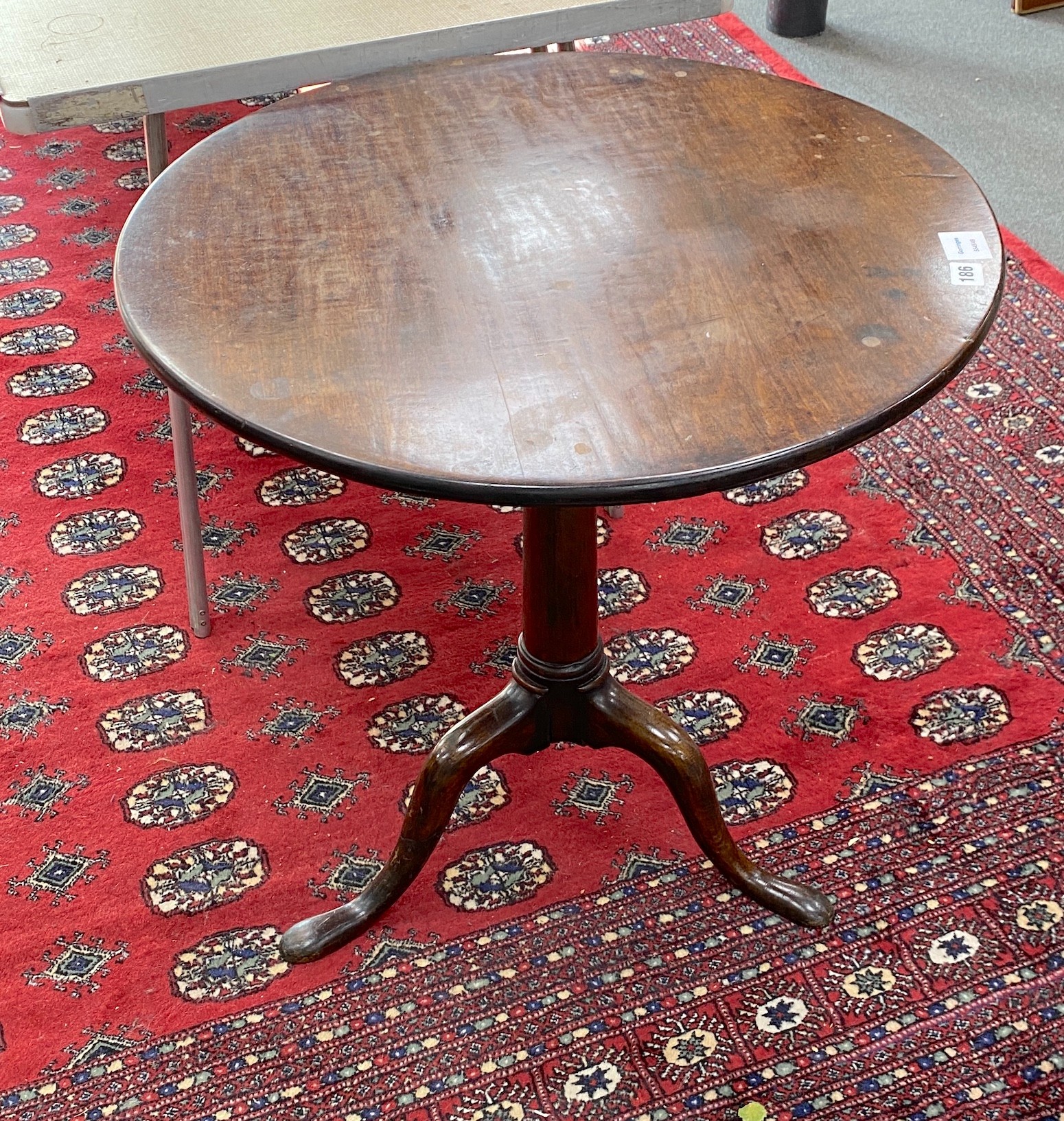 A George III mahogany circular tilt top tea table, with 'bird-cage' pillar and tripod supports, diameter 64cm, height 69cm